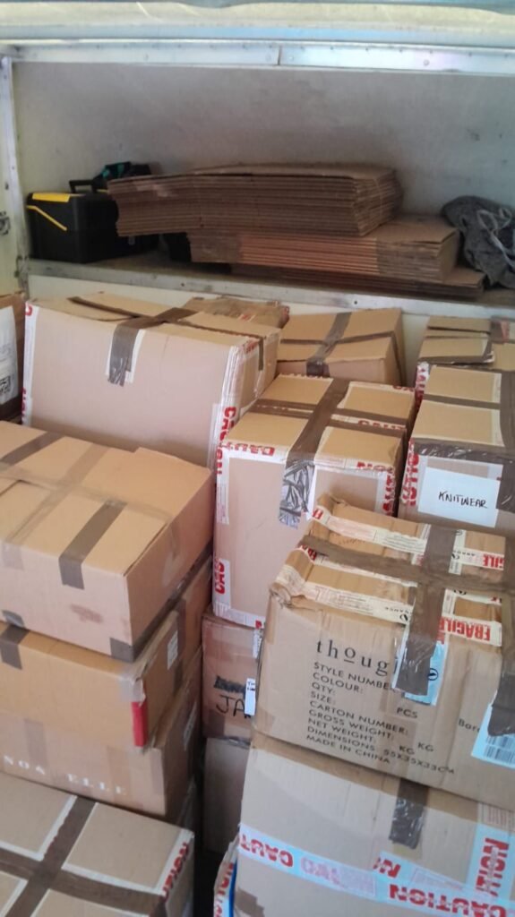 Commercial knitwear stock crates loaded for long-distance delivery from London