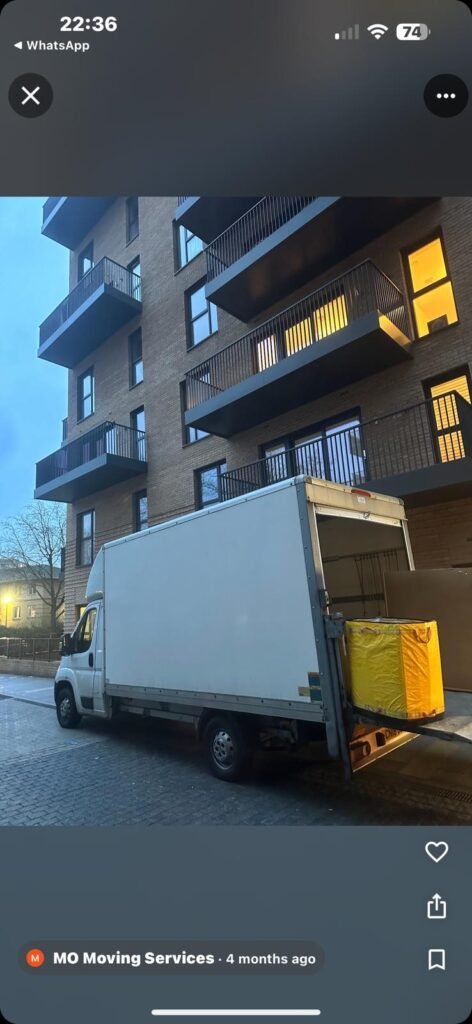 Flat removals London — Luton van outside modern apartment block at dusk
