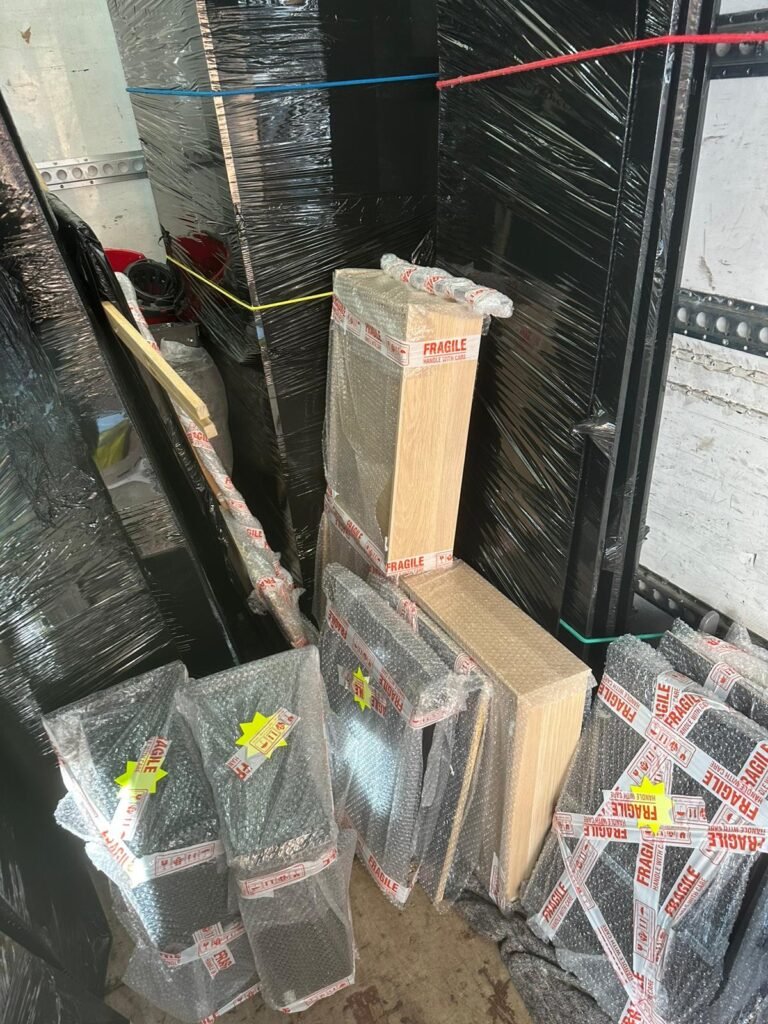 Fragile items wrapped in protective film with FRAGILE tape — Man and Van London