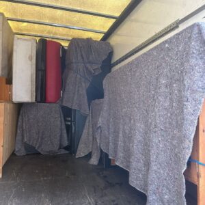 Fragile items service — suitcases and red items wrapped for transport