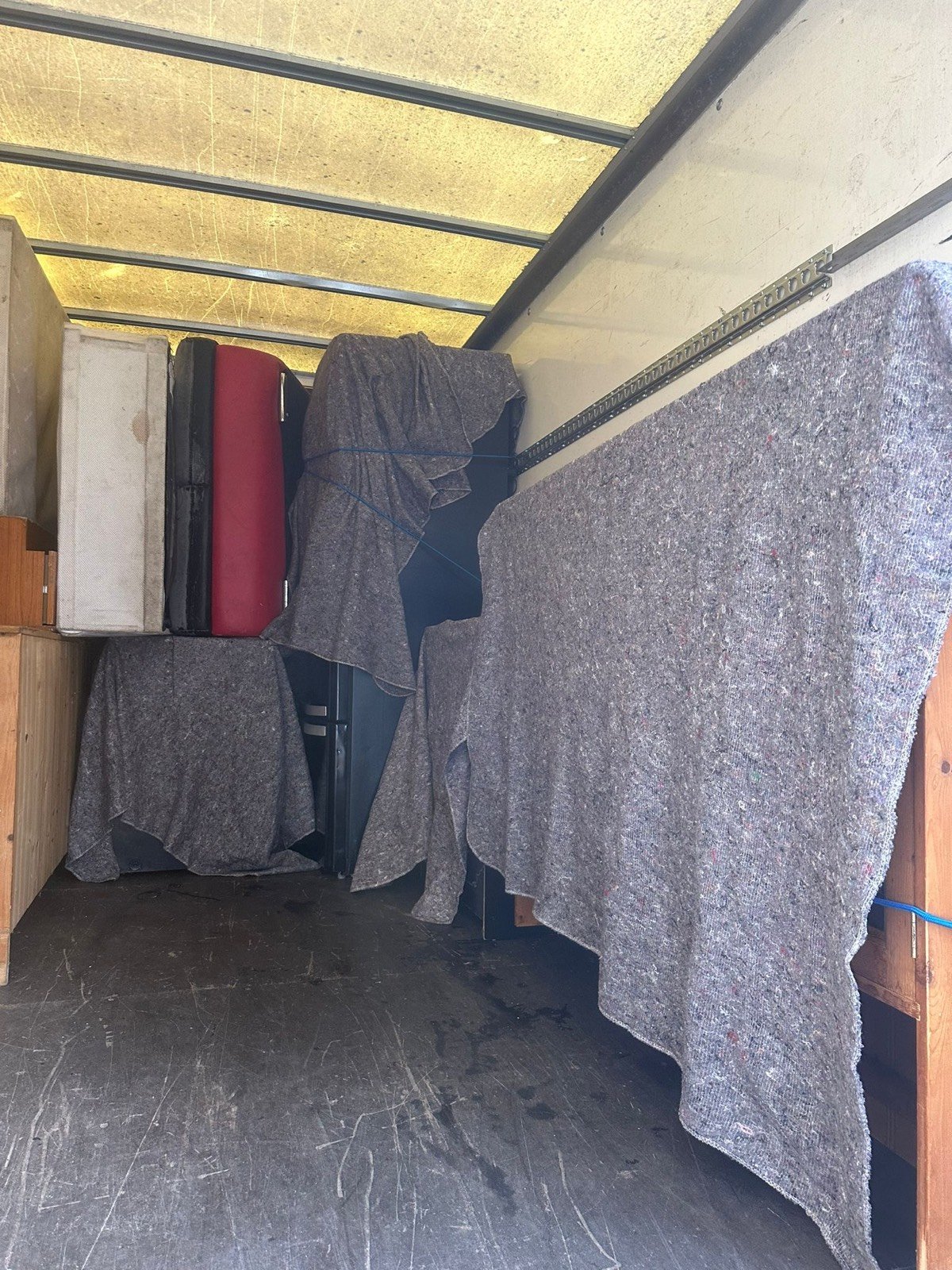 Fragile items service — suitcases and red items wrapped for transport