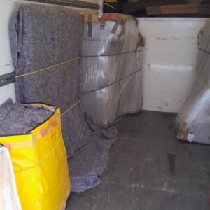 House removals van loaded with blanket-wrapped furniture — London