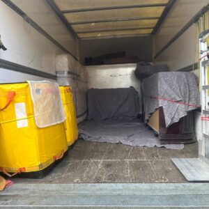 House removals van loaded with blanket-wrapped furniture — London