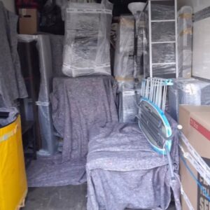 House removals van loaded with blanket-wrapped furniture — London