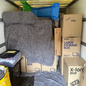 House removals van loaded with blanket-wrapped furniture — London