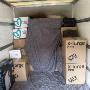 House removals van loaded with blanket-wrapped furniture — London