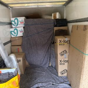 House removals van loaded with blanket-wrapped furniture — London