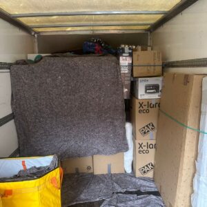 House removals van loaded with blanket-wrapped furniture — London