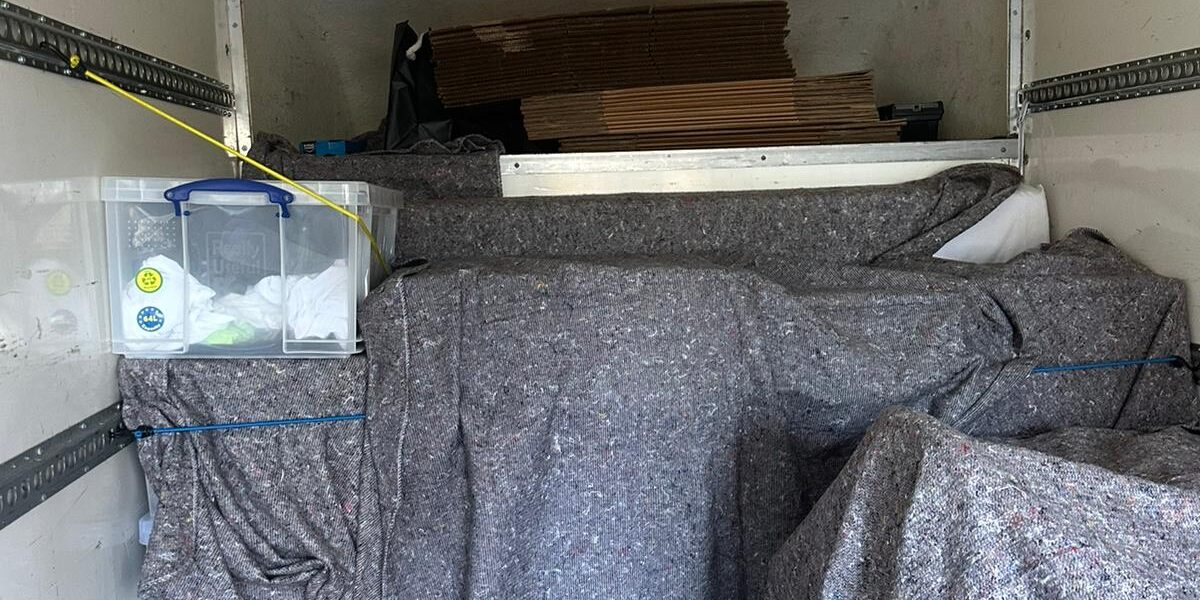 Man and Van loaded with blanket-wrapped furniture — London removal