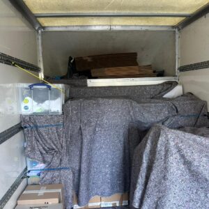 Man and Van loaded with blanket-wrapped furniture — London removal