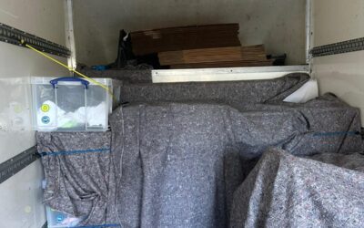 Man and Van loaded with blanket-wrapped furniture — London removal