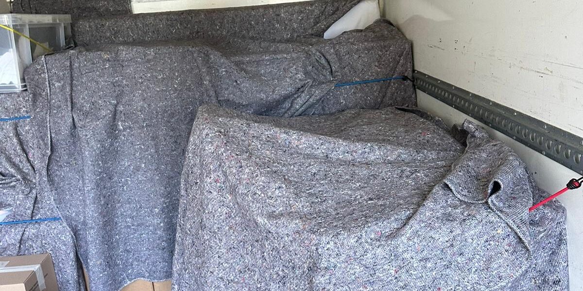 Office chair blanket-wrapped inside van — office removals London