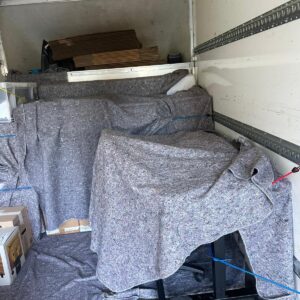 Office chair blanket-wrapped inside van — office removals London
