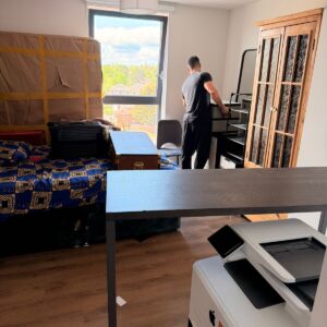 Professional packing service — mover wrapping furniture in London