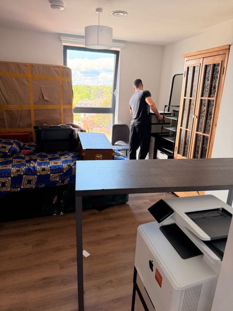 Professional packing service — mover wrapping furniture in London