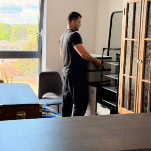 Professional packing service — mover wrapping furniture in London