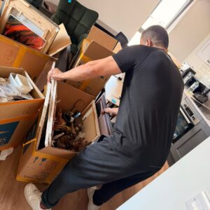 Professional packing service — mover wrapping furniture in London