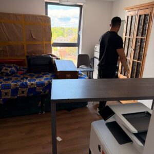 Professional packing service — mover wrapping furniture in London
