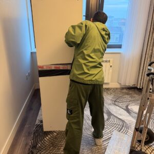 Professional packing service — mover wrapping furniture in London