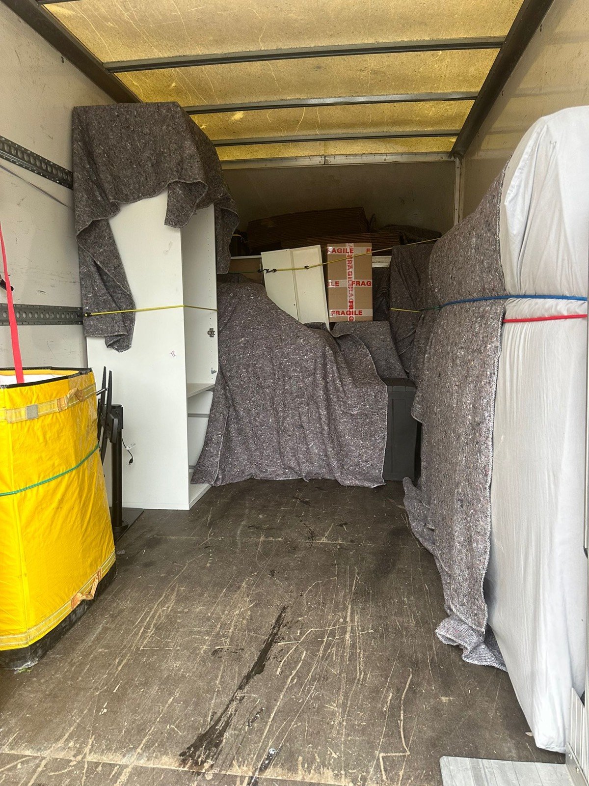Single-item delivery — washing machine moved into a London kitchen