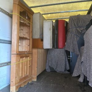 Furniture delivery London — antique wood corner cabinet loaded into van